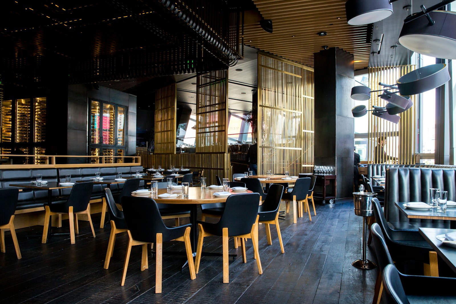 Warmly lit restaurant interior with tables and seating, evoking dining out and menu choices.