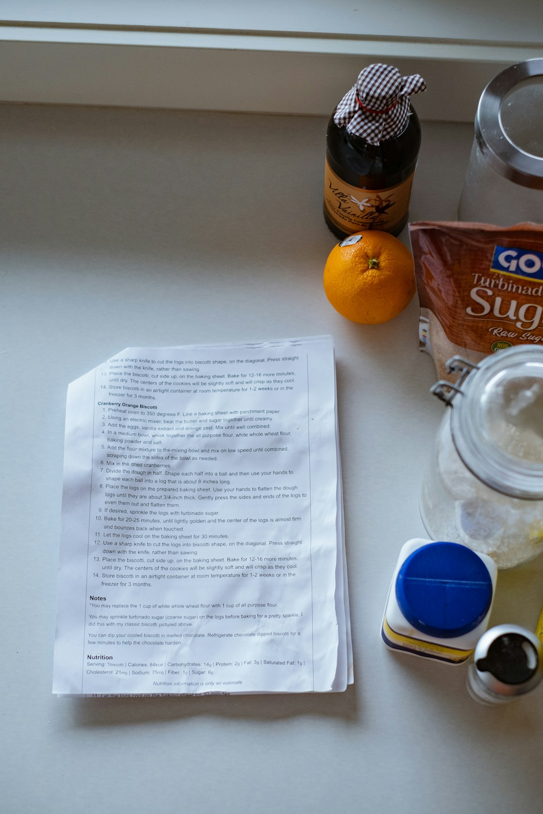 Organized small bowls of ingredients and a notebook used for testing foods in a kitchen.