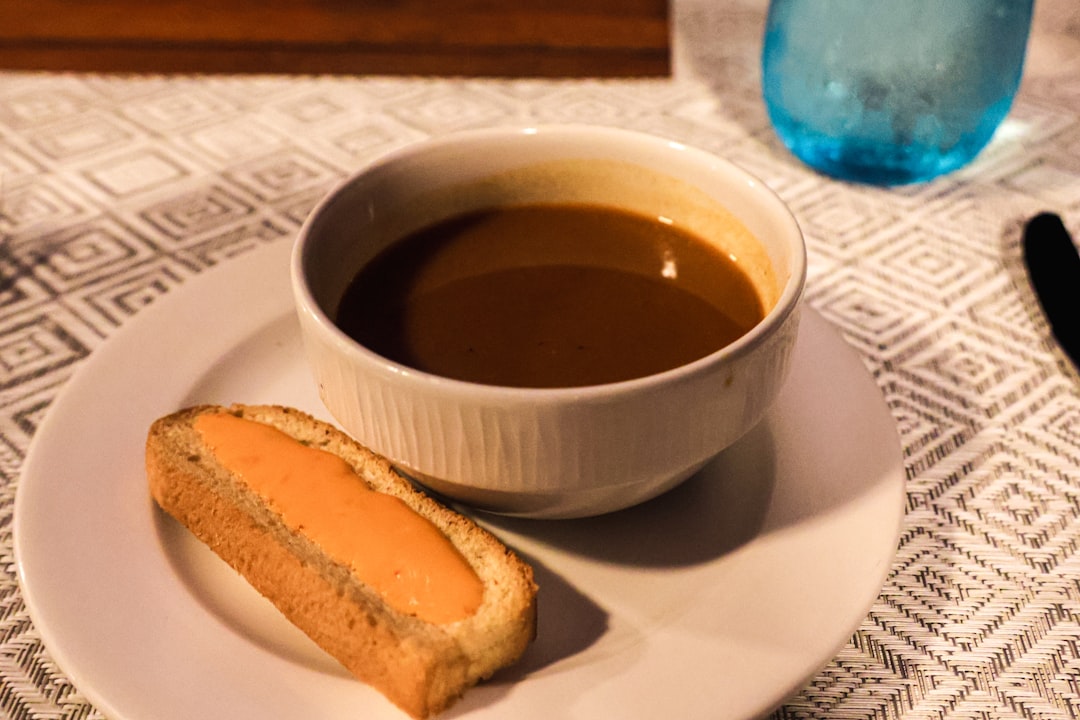 Simple meal tray with rice, soup, toast, and tea arranged neatly on a light table.