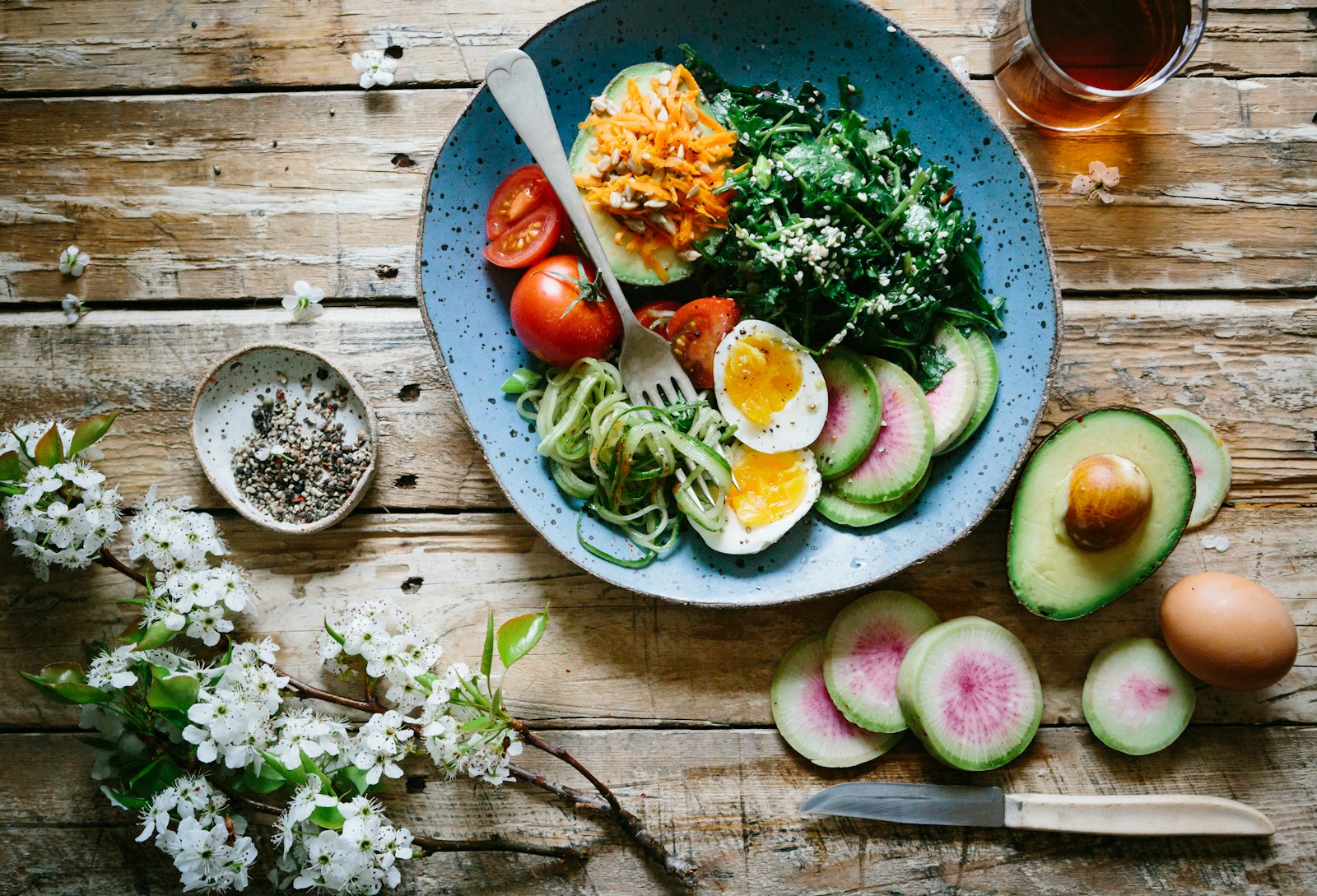 Table spread with eggs, fruit, avocado, and whole grains, illustrating everyday nutrient-rich meals.